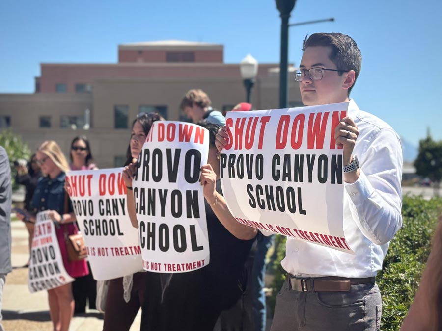 Demonstrators at a news conference show support for parents suing the Provo Canyon School on June 15, 2026. | Annie Knox, Utah News Dispatch