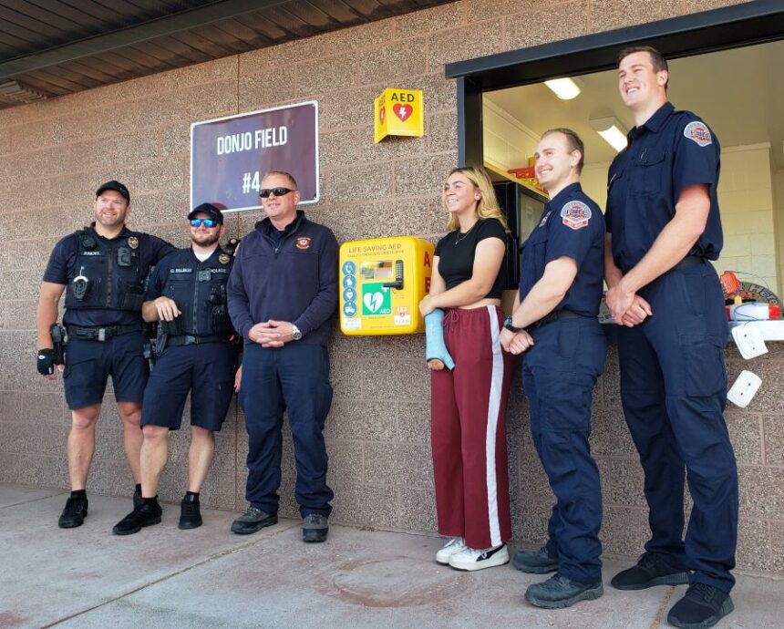 Addie Cox and Rigby officials pose with a new Automated External Defibrillator installed at Donjo Sports Complex in Rexburg. | Allan Steele, EastIdahoSports.com.