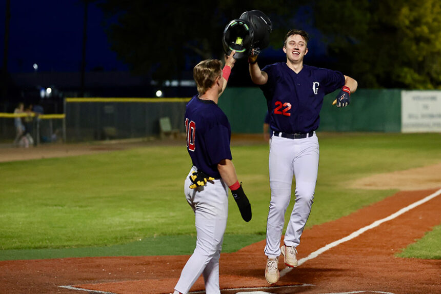 Grays baseball Kolby Landon (10) greets Boston Ross (22) at home following Ross' homer
