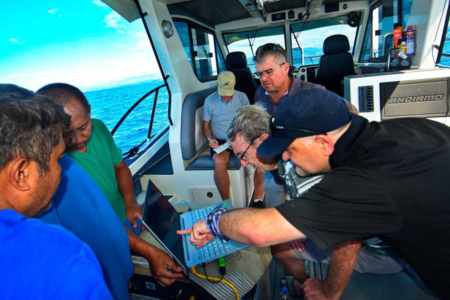 The team monitors a computer during a sonar scan on Dec. 16, 2025.