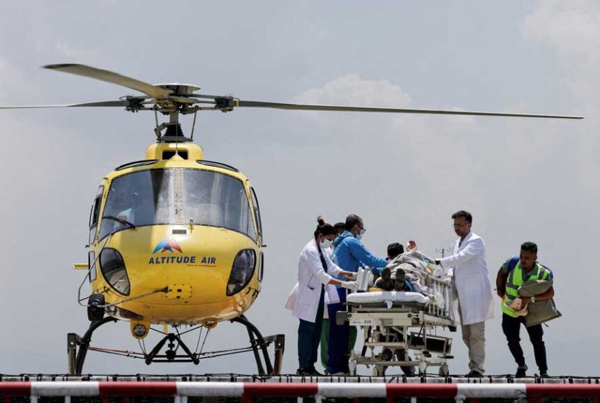 Paramedics transport Dawa Sherpa, who was missing for several days in the Everest region, from the helipad at HAMS Hospital in Kathmandu, Nepal, June 4.