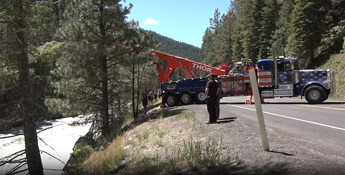 Crews watch on as a tow truck pulls the truck from the Payette River. | KIVI