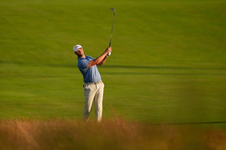 Wyndham Clark hits from the fairway on the third hole during the first round of the U.S. Open golf tournament at Shinnecock Hills Golf Club in Southampton, N.Y., Thursday, June 18, 2026.(AP Photo/David J. Phillip)