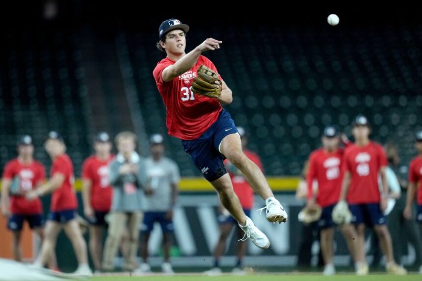 Archer Horn, a shortstop from St. Ignatius High School, throws to first base at the MLB baseball combine in Phoenix, Tuesday, June 23, 2026. (AP Photo/Ross D. Franklin)