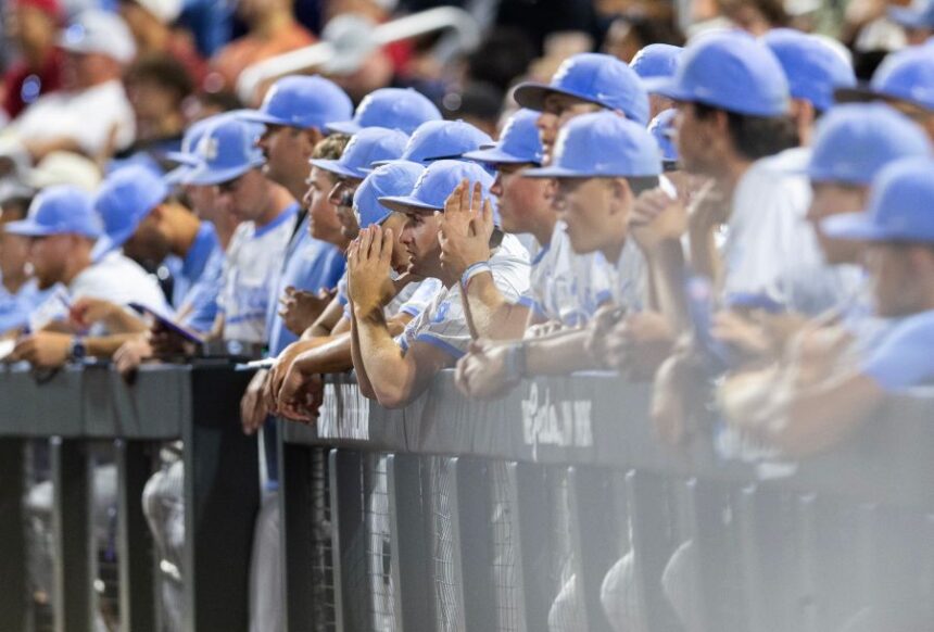 North Carolina players watch from the dugout as Oklahoma goes to bat in the ninth inning of Game 3 of the NCAA College World Series baseball finals in Omaha, Neb., Monday, June 22, 2026. (AP Photo/Rebecca S. Gratz)