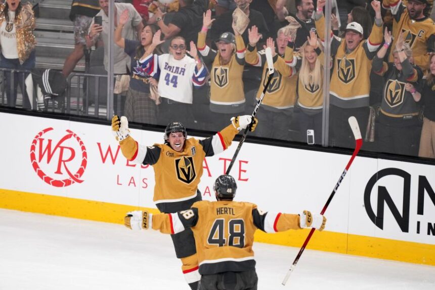 Vegas Golden Knights right wing Mitch Marner, top, celebrates his goal with center Tomas Hertl during the second period in Game 3 of the NHL hockey Stanley Cup Final series against the Carolina Hurricanes, Saturday, June 6, 2026, in Las Vegas. (AP Photo/Candice Ward)