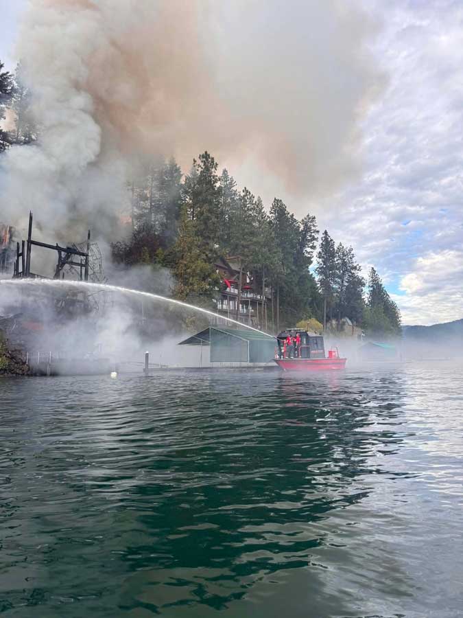 Firefighters from Northern Lakes Fire Protection District work to extinguish a massive house fire at Hayden Lake, in Kootenai County, on Friday, June 19, 2026.