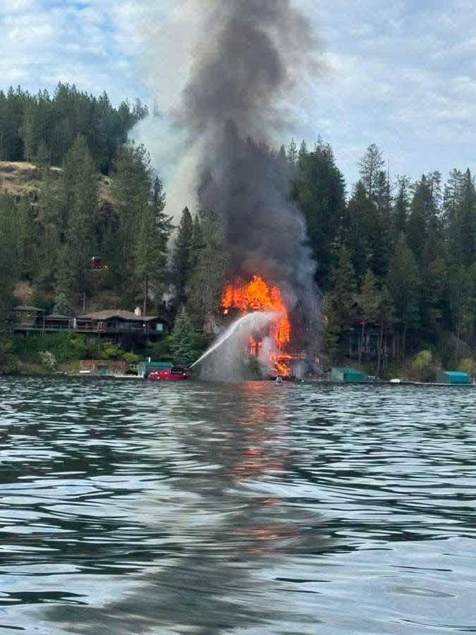 Firefighters from Northern Lakes Fire Protection District work to extinguish a massive house fire at Hayden Lake, in Kootenai County, on Friday, June 19, 2026.