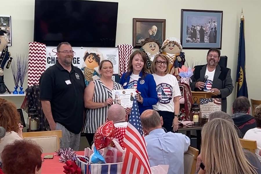 America250 in Idaho Service Challenge Committee Chairman Jessica Cooper Whiting, second from right, recognizes Idaho Falls Community Food Basket Executive Director Ariel Jackson, second from left, and her husband during Thursday's celebration. | Rett Nelson, EastIdahoNews.com