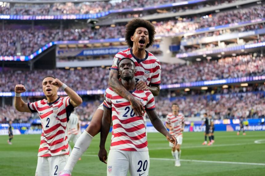 United States' Folarin Balogun (20) celebrates scoring his side's third goal against Paraguay with teamates during the World Cup Group D soccer match in Inglewood, Calif., near Los Angeles, Friday, June 12, 2026. (AP Photo/Andre Penner)