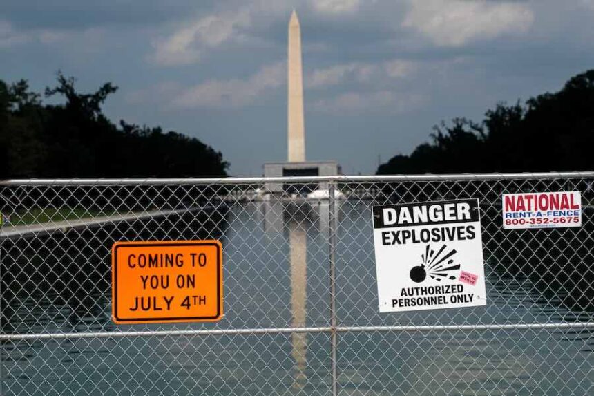 Signage and security fencing warns of explosives along the Lincoln Memorial Reflecting Pool ahead of July 4th events on the National Mall, Wednesday, July 1, 2026, in Washington.