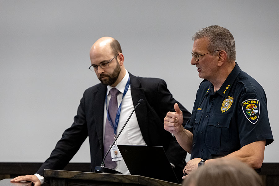Idaho Falls City Attorney Zachary Jones and Idaho Falls Police Chief Bryce Johnson talking at Thursday night's city council meeting. | Daniel V. Ramirez, EastIdahoNews.com
