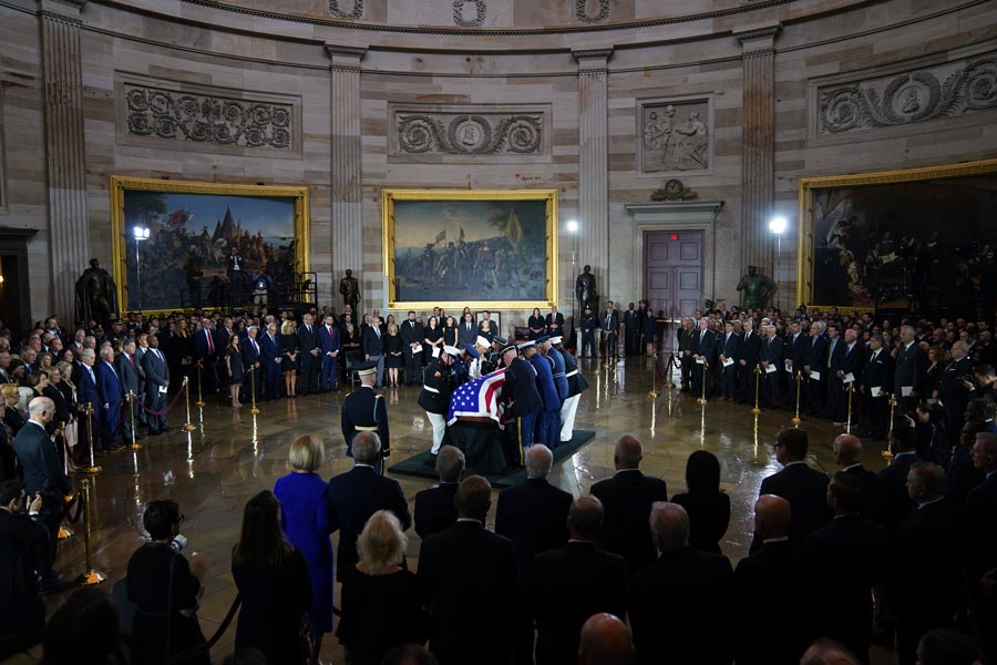 An Armed Forces Body Bearer Team places the flag-draped casket of Sen. Lindsey Graham of South Carolina, in the Rotunda of the U.S. Capitol, Tuesday, July 28, 2026, in Washington. (AP Photo/Allison Robbert)