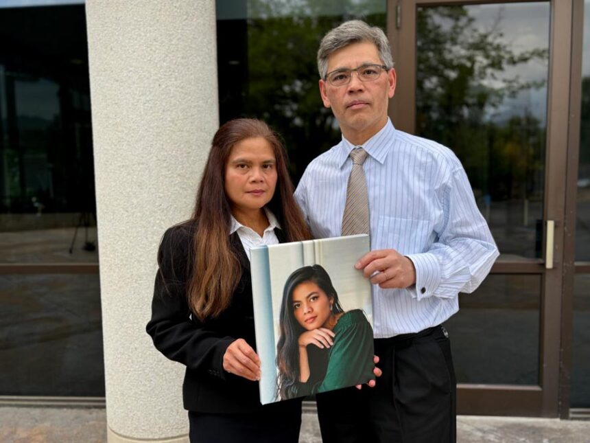Rose and Keith Nguyen pose with a portrait of their daughter, Rena Nguyen, at the offices of the Utah State Bar in Salt Lake City on Friday, July 17, 2026. (Annie Knox/Utah News Dispatch)