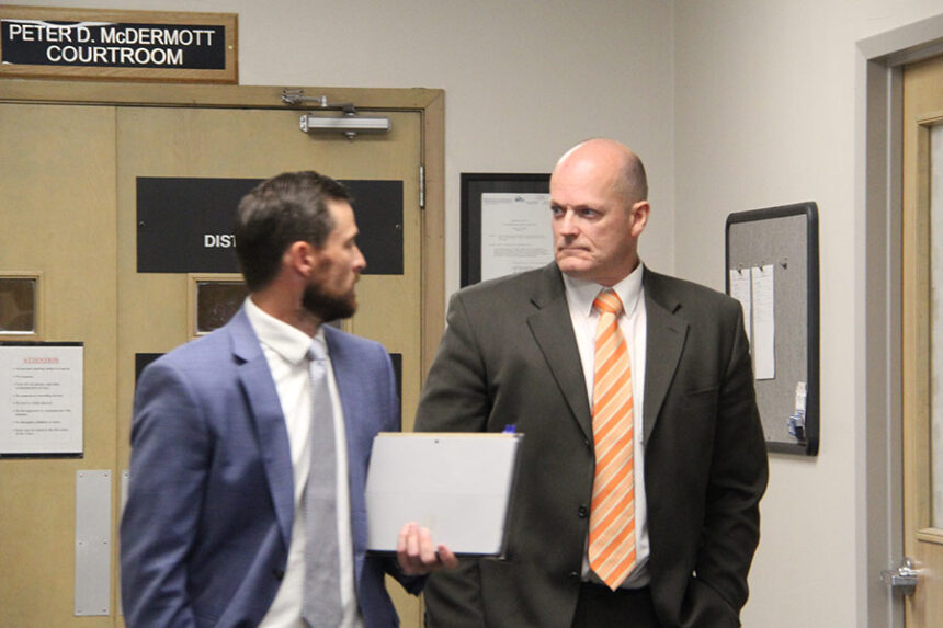 Virgil Larson (right) leaves the courtroom with his attorney, Stratton Laggis (left).