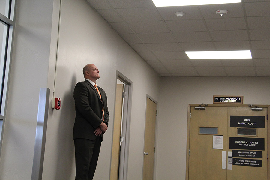 Virgil Larson waits outside the courtroom during a recess.