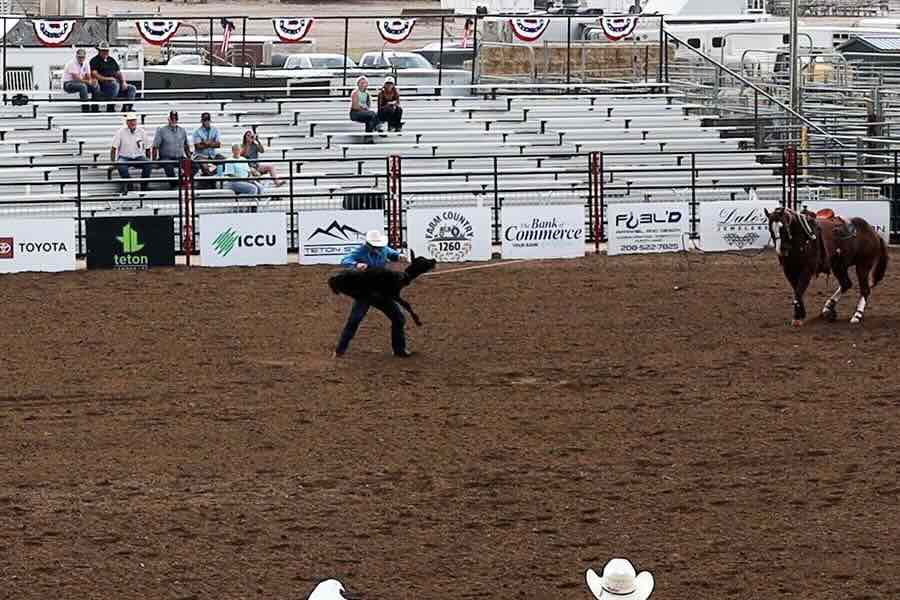 A cowboy demonstrates how to rope a calf in a rodeo competition during a press event at Sandy Downs, on Wednesday, July 29, 2026, in Idaho Falls.