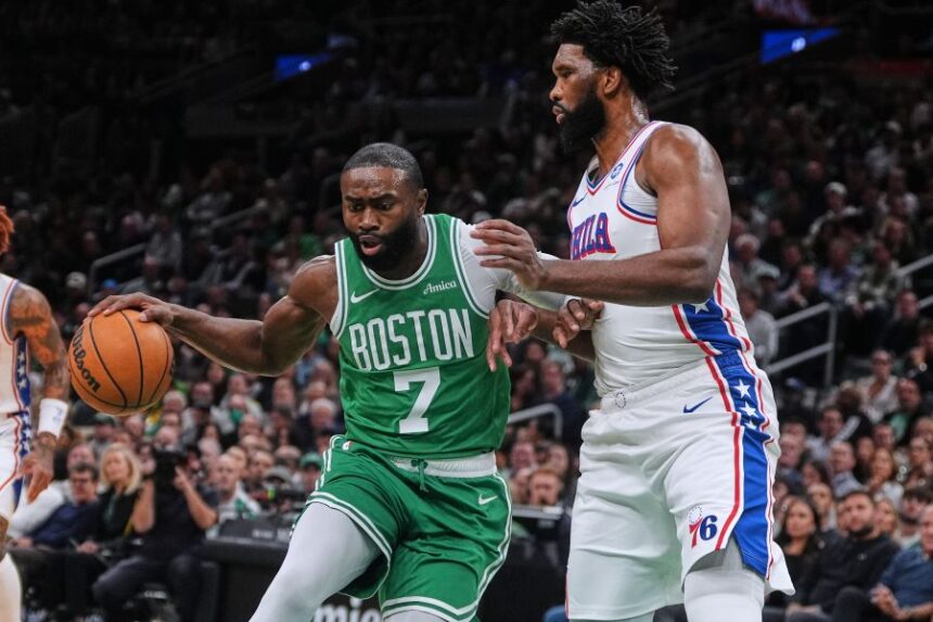 FILE - Boston Celtics forward Jaylen Brown (7) drives to the basket against Philadelphia 76ers center Joel Embiid, right, during the first half of an NBA basketball game, Wednesday, Oct. 22, 2025, in Boston. (AP Photo/Charles Krupa,File)