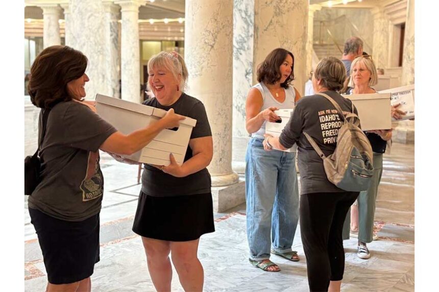 Volunteers pass boxes full of signed ballot initiative petitions through the Idaho Capitol on July 2. If approved for November’s ballot and then by voters, the proposed Reproductive Freedom and Privacy Act would restore abortion access “without government interference” until fetal viability, and would protect fertility treatments and other reproductive care such as contraception. (Photo by Kelcie Moseley-Morris/Stateline)