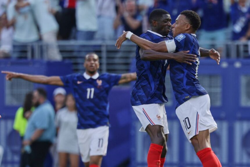 -France's Kylian Mbappe (10) celebrates their first goal with Ousmane Dembele, left, during the World Cup round of 32 soccer match between France and Sweden in East Rutherford, N.J., near New York, Tuesday, June 30, 2026. (AP Photo/Adam Hunger)