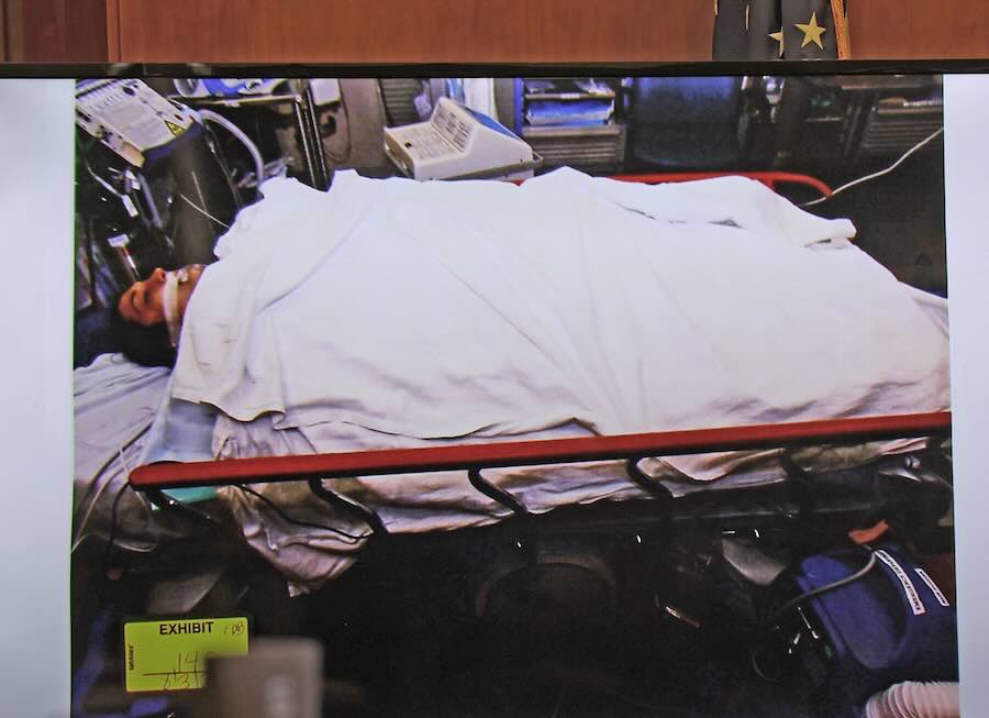 A photo entered into evidence of Lindsay Clancy in the South Shore Hospital ER, covered in warming blankets. Clancy is on trial for murdering her three young children in 2023 at their Duxbury, Mass., home.
