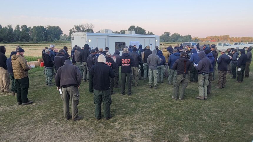 Fire crews in their morning meeting before heading up the hill to fight the Big Rock Fire near Heise. | USWFS Great Basin