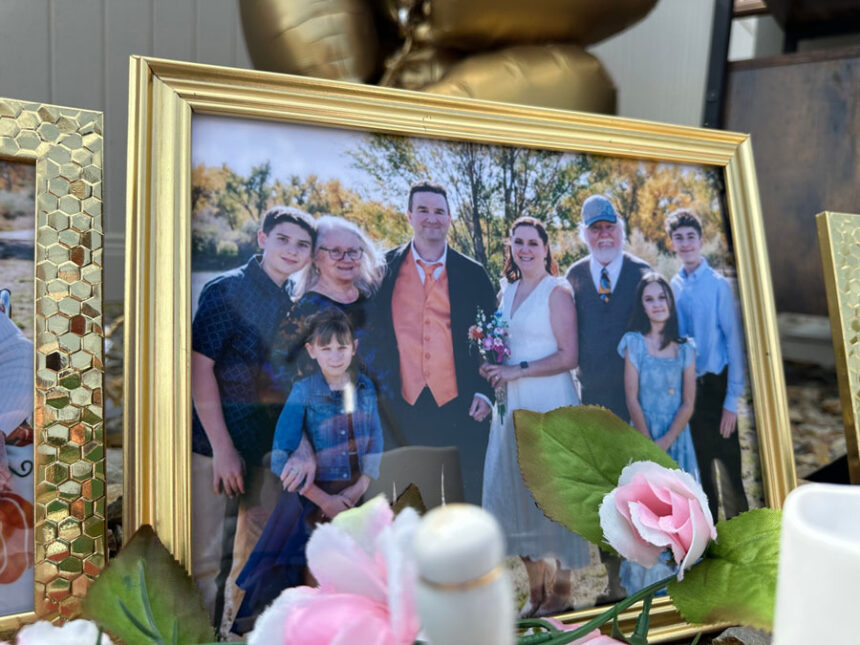 A wedding photo taken by Miranda Murdock that shows relatives who were killed in a home outside Billings, Mont., is displayed at a memorial site on Wednesday, Aug. 26, 2026. (AP Photo/Matthew Brown)