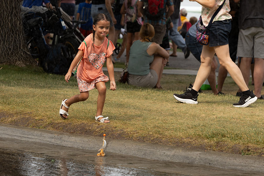 A girl playing with the water runoff from the Idaho Falls Fire Department's water station, that helped cool off local residents. | Daniel V. Ramirez, EastIdahoNews.com