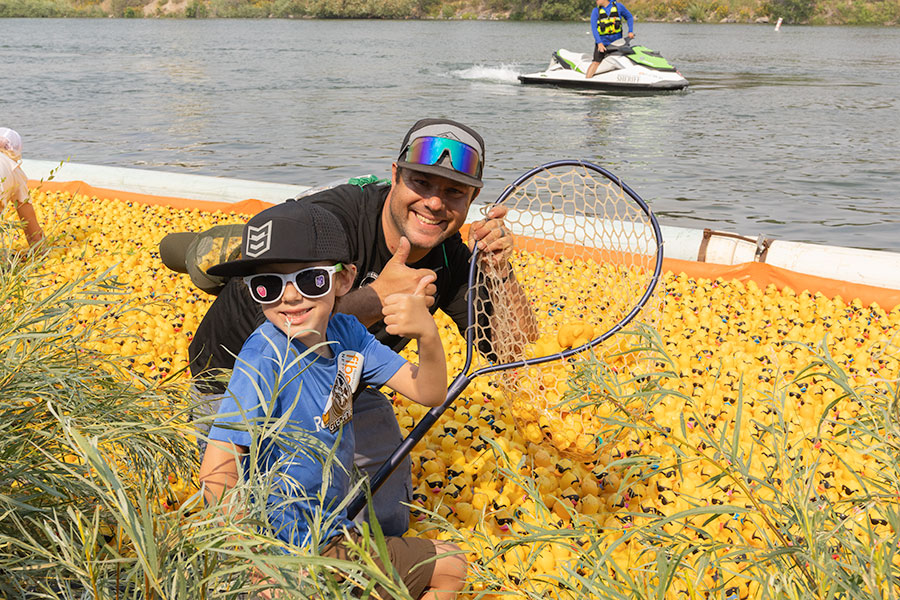 Chad and Jasper Wheeler, among other locals, hopped into the Snake River to help pick up 30,000 ducks. | Daniel V. Ramirez, EastIdahoNews.com
