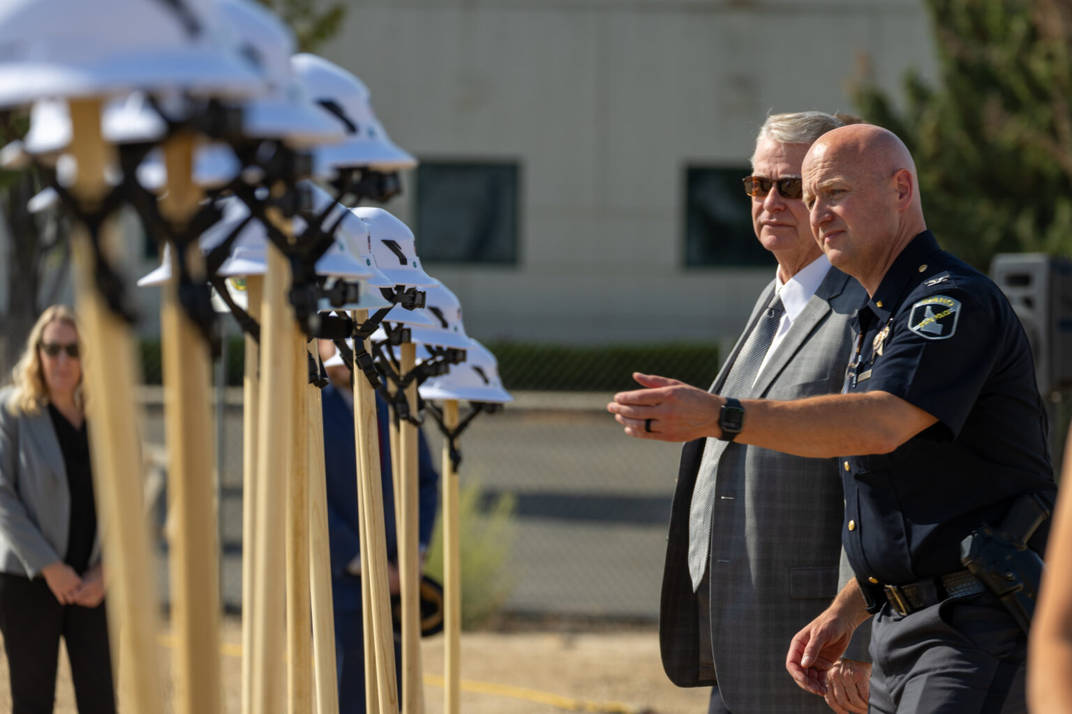 Idaho State Police’s director, Col. Bill Gardiner, reached toward a shovel at a groundbreaking ceremony next to Gov. Brad Little on Aug. 25, 2026. | Kyle Pfannenstiel, Idaho Capital Sun