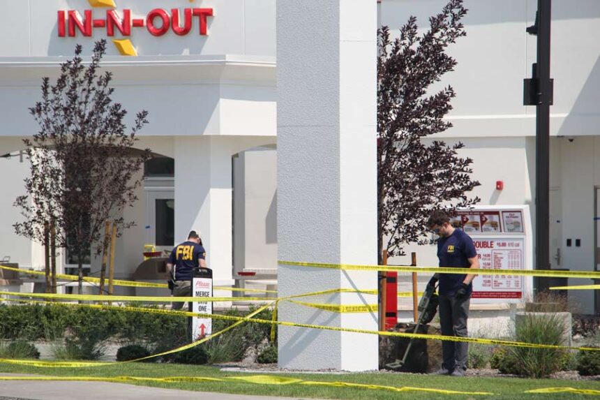 FBI personnel search the scene of the shooting.