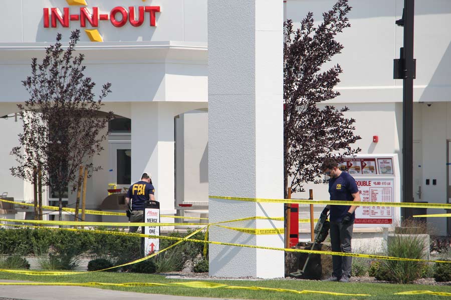 FBI personnel search the scene of the shooting.