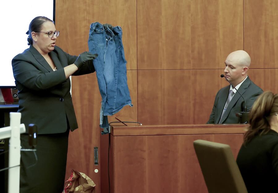 Prosecutor Shanan Buckingham, left, shows a pair of jeans worn by Lindsay Clancy to witness Mass. State Police Sgt. Dan Lawlor, during Clancy's murder trial at Plymouth Superior Court, Wednesday, Aug. 12, 2026, in Plymouth, Mass.