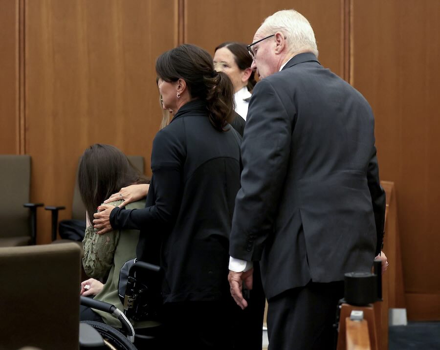 Defense attorney Kevin Reddington, right, and Lindsay Clancy’s caretakers wheel Clancy out of the courtroom as she sobs uncontrollably during her murder trial at Plymouth Superior Court, Wednesday in Plymouth, Mass.