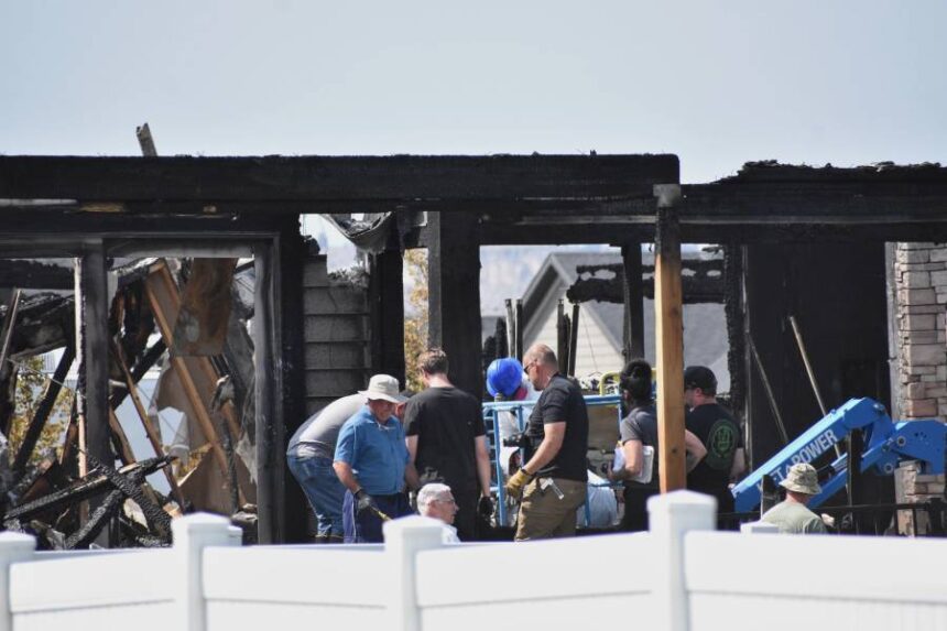 Investigators work at the scene Tuesday, Aug. 25, 2026, where a family was killed and the house burned in Billings, Mont. | AP Photo/Matthew Brown