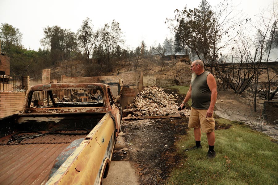 Allen Sather stands in front of his 1968 Chevrolet C20 at the duplex he rented on W. Indian Trail Rd. that burned in the a wildfire in Spokane, Wash., Sunday, Aug. 2, 2026. (AP Photo/Young Kwak)