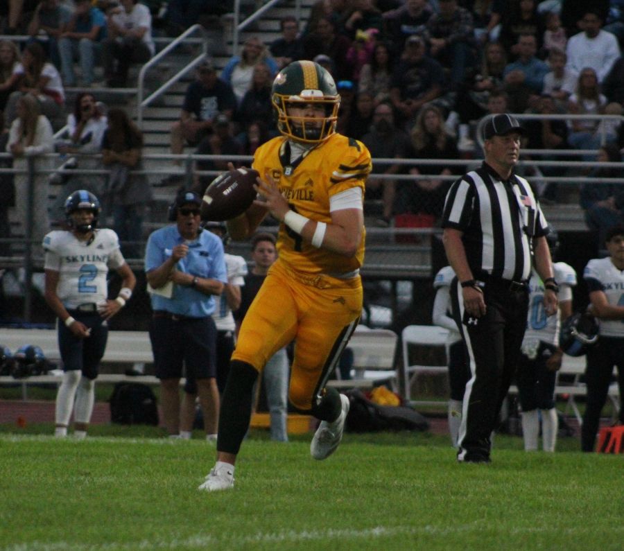 Bonneville quarterback Jaxton Briggs moves out of the pocket during Friday's game. | Allan Steele, EastIdahoSports.com.