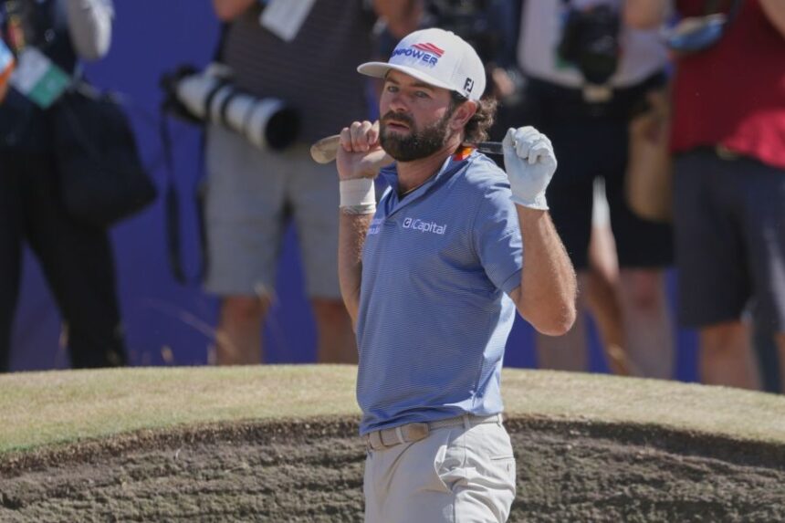 Cameron Young of the United States reacts after playing out of a bunker on the 18th green during the final day of the British Open Golf championships at Royal Birkdale golf club, in Southport, England, Sunday, July 19, 2026. (AP Photo/Peter Morrison)