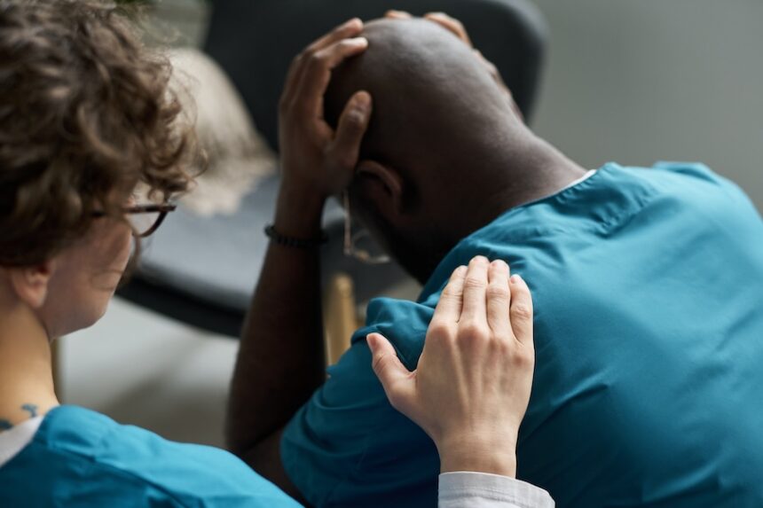 healthcare worker consoling colleague in hospital 2026 03 25 08 30 28 utc