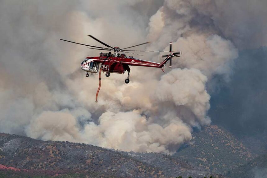 A Sikorsky Skycrane maneuvers into position to refill during efforts to fight the Widemouth 2 Fire east of Fillmore, Utah, on Tuesday, Aug. 4, 2026, before it crashed on Friday, Aug. 7. (Scott G Winterton/The Deseret News via AP)