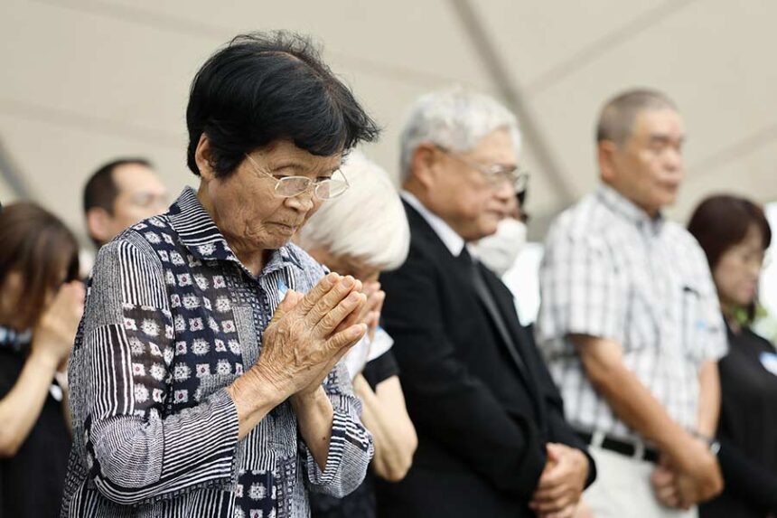 People observe a minute of silence during a ceremony to mark the 81st anniversary of the U.S. atomic bombing at the Peace Park in Nagasaki, southern Japan Sunday, Aug. 9, 2026. (Taichi Nagahisa/Kyodo News via AP)