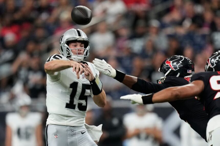Las Vegas Raiders quarterback Fernando Mendoza (15) throws against the Houston Texans while under pressure during the first half of an NFL preseason football game, Thursday, Aug. 20, 2026, in Houston. (AP Photo/Ashley Landis)