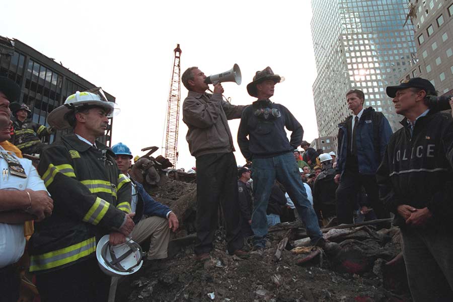 Standing Atop Rubble with Retired New York City Firefighter Bob Beckwith, President George W. Bush Addresses Approximately 400 Police, Firemen and Rescue Workers by Bullhorn at the Site of the Collapsed World Trade Center in New York City. September 14, 2001. (U.S. National Archives')