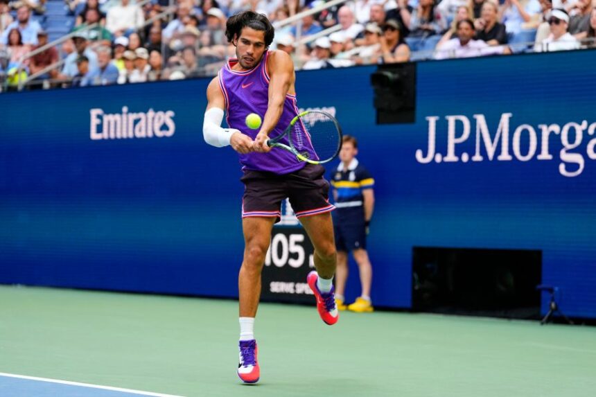 Carlos Alcaraz, of Spain, returns the ball during a mixed doubles match at the U.S. Open tennis championships, Tuesday, Aug. 25, 2026, in New York. (AP Photo/Yuki Iwamura)