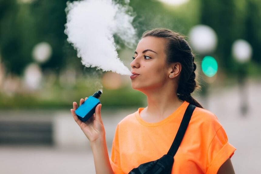 woman vaping outside in an urban environment 2026 03 18 04 34 57 utc