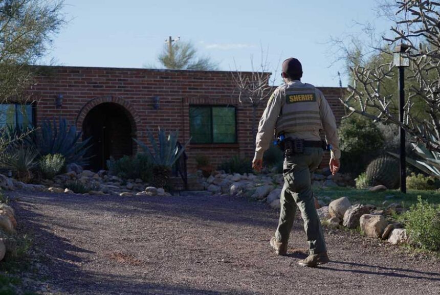 A member of the Pima County Sheriff's Office remains outside Nancy Guthrie's home on Monday, Feb. 9, 2026, in Tucson, Ariz.
