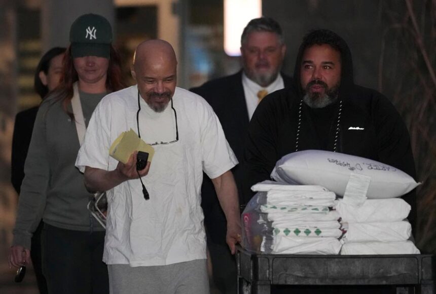 Douglas Stewart Carter, front left, and his son Tyler Anger, right, walk out of the Utah County Jail after a Utah judged ordered Carter's release from jail on Monday Sept. 28, 2026, in Spanish Fork, Utah. | George Frey, Associated Press
