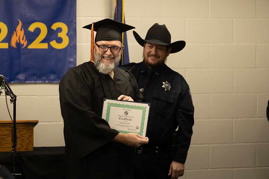 An inmate at the Bonneville County Jail, Brain Moore holds his GED diploma during Thursday's graduation event. | Daniel V. Ramirez, EastIdahoNews.com