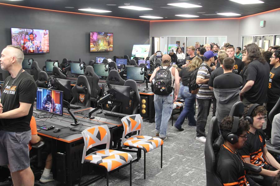 People file in and out of the room past rows and rows of computers.