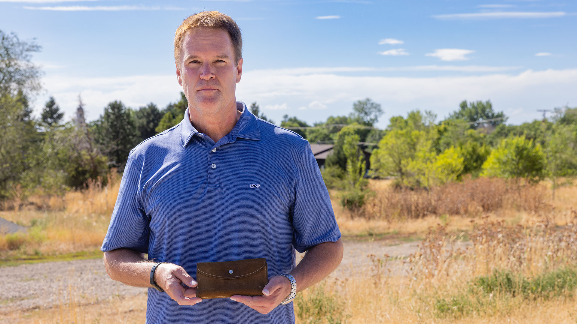 Brant Baird holds his missing mother Nancy Baird's wallet at the place where Nancy was last seen, on July 4, 1975. For nearly 50 years, Nancy's disappearance was wrongfully attributed to serial killer Ted Bundy.